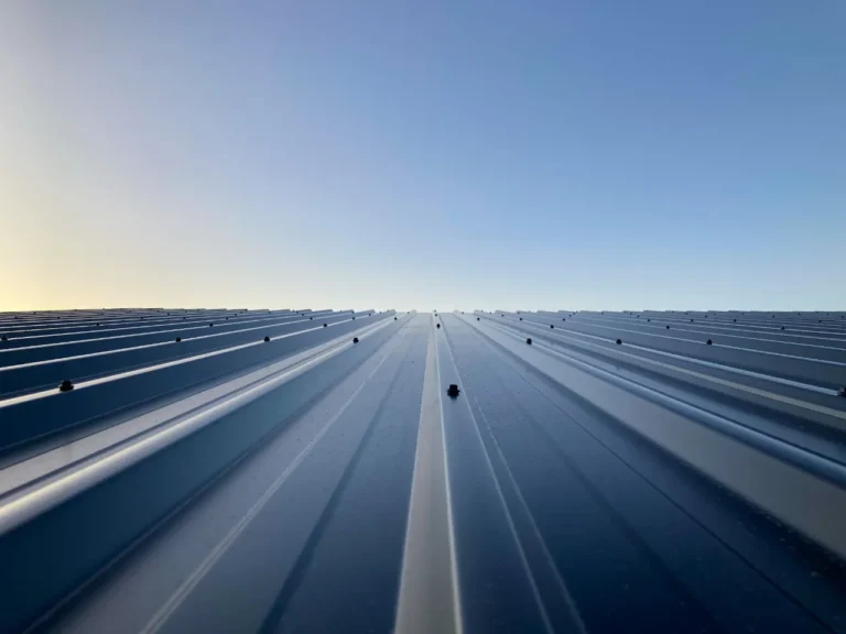 Metal roofing panels against a clear sky
