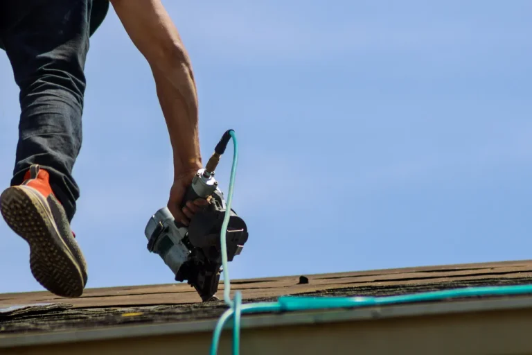 Roof repair with a nail gun on a rooftop